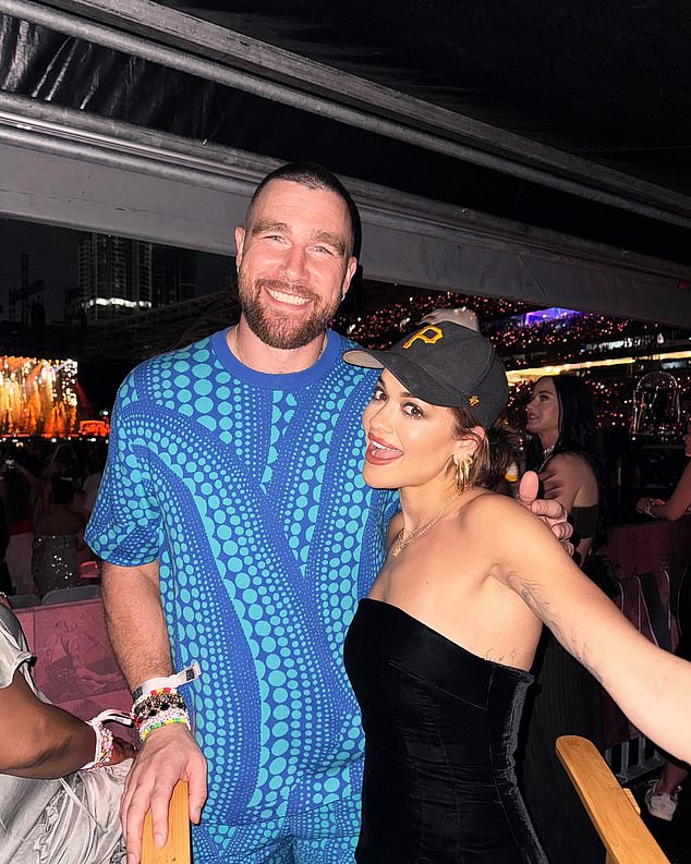 The Chiefs tight end flashed a big smile as he towered over Rita Ora in a photo.