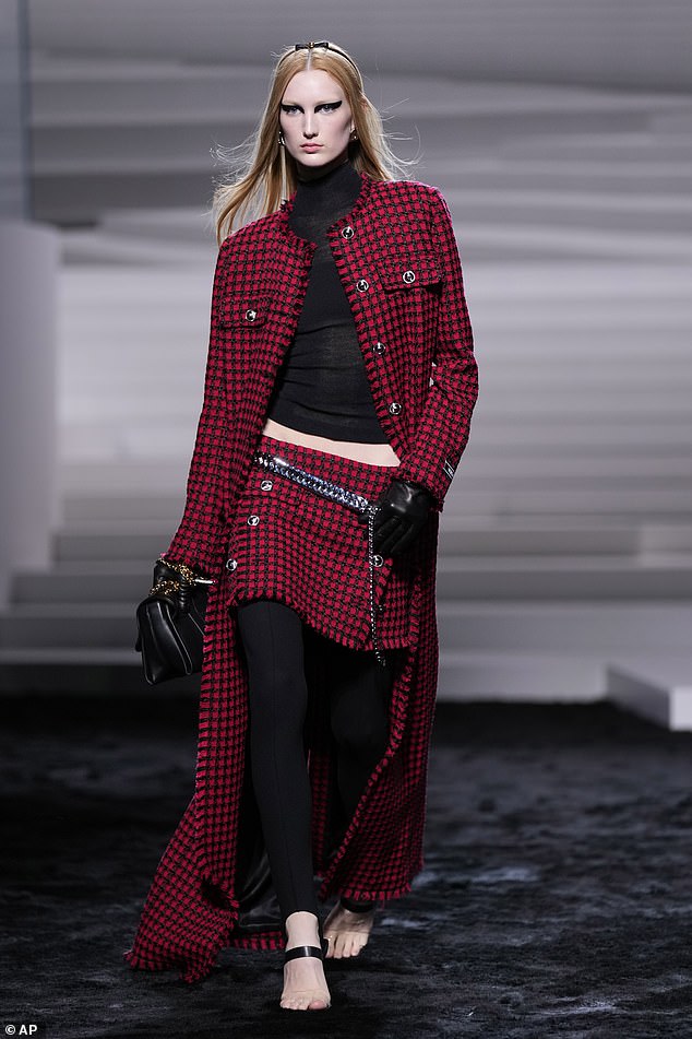 A model wore a red plaid ensemble as part of Versace's Fall/Winter 2024-2025 womenswear collection.