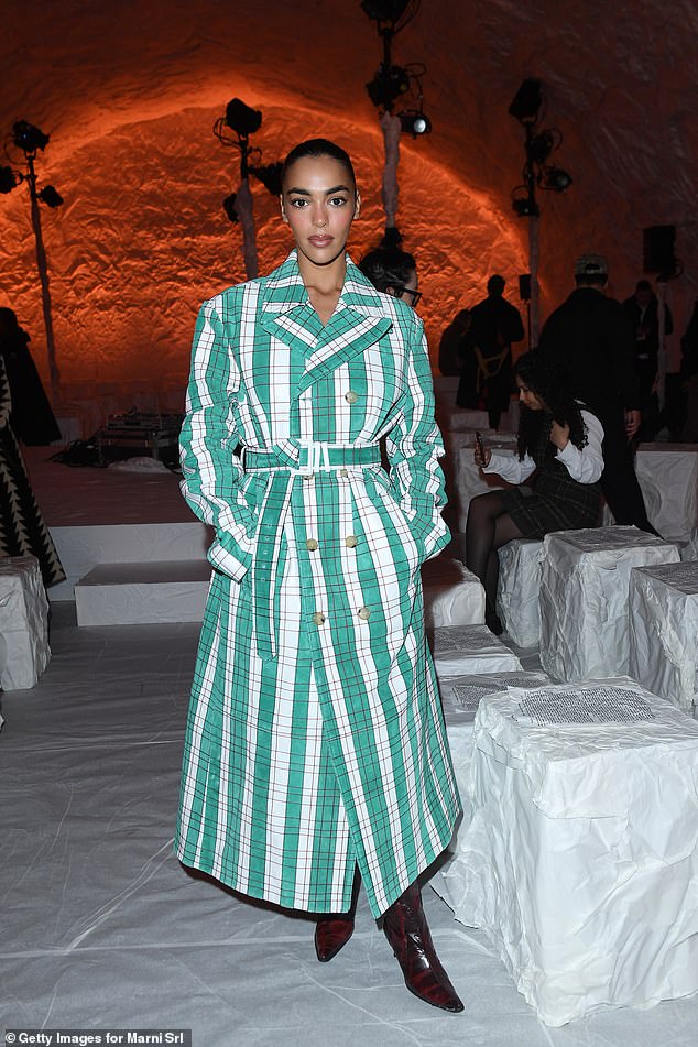 The internet star, 27, made a fashion statement in a pine green plaid wrap long coat dress.