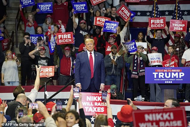 Former President Donald Trump arrives at his rally on the eve of the South Carolina primary in Rock Hill, South Carolina. The Republican front-runner touted MAGA economics in the hour-and-a-half-long speech and also said the stock market would crash if he lost to President Joe Biden.