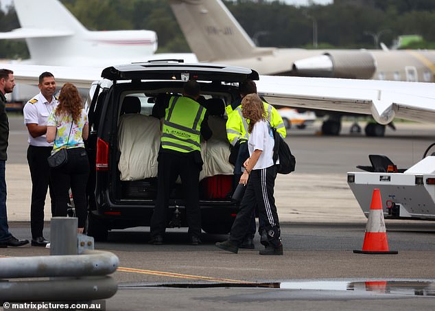 Members of airport staff were seen removing their belongings from the vehicle.