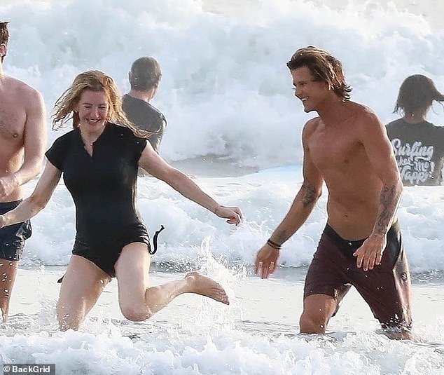 Ellie's carefree day on the beach in Costa Rica as she frolics in the waves with Armando