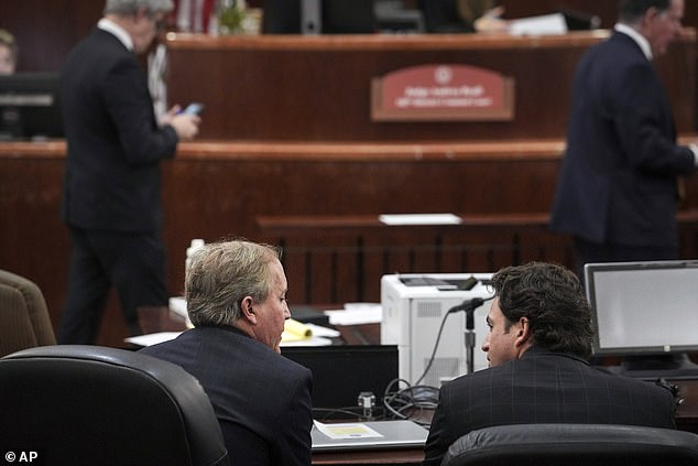 Texas Attorney General Ken Paxton, front left, speaks with his defense attorney Anthony Osso, Jr., during a hearing in his securities fraud case, Friday, Feb. 16, in Texas County Criminal Court. Harris in Houston. A judge on Friday rejected Paxton's attempts to dismiss felony securities fraud charges that have dogged the Republican for nearly a decade.