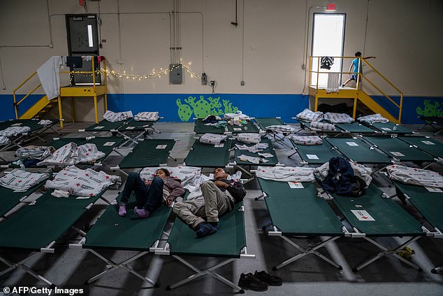 Migrant children from different Latin American countries rest on cots inside one of several shelters run by Annunciation House in El Paso, Texas.