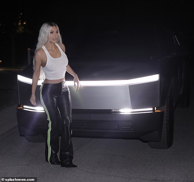 Her sleek boot-cut pants featured a pop of color while green stripes decorated the sides. The Kardashian star paired the combo with a pair of pointed-toe heeled boots.