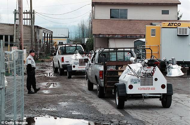Investigators are seen at the Pickton pig farm in British Columbia, Canada, in April 2002, as part of a year-long, $70 million excavation of the property that revealed gruesome evidence of murders.