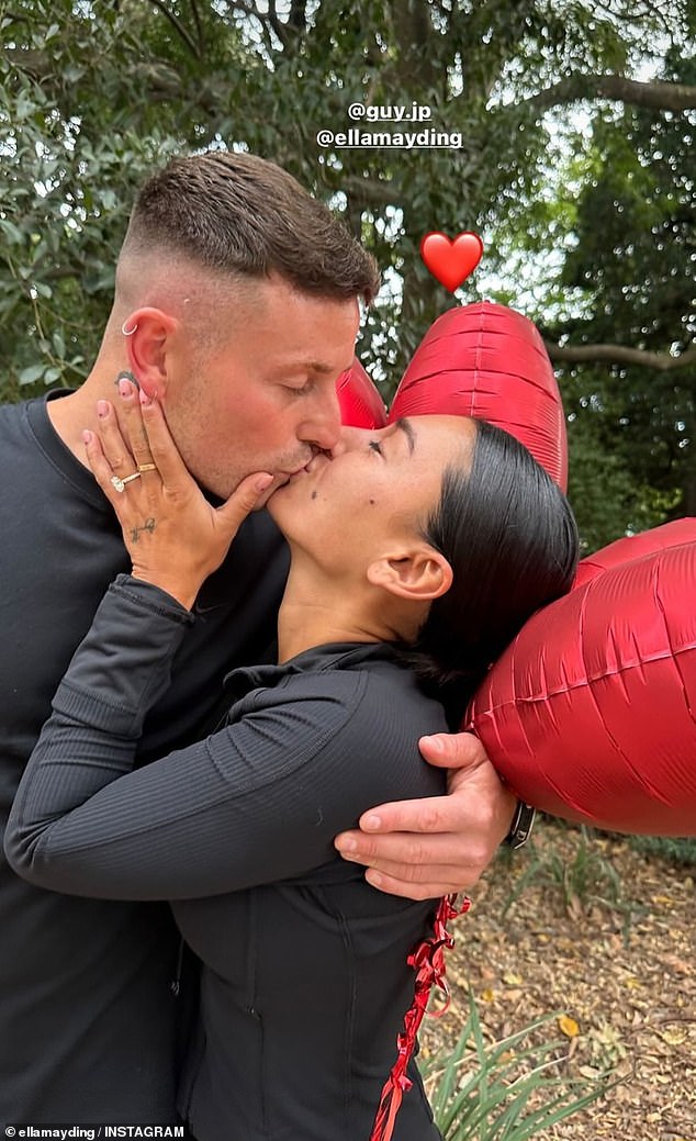 The couple's loved ones surprised them with red love heart balloons as they marked the special moment with a kiss.