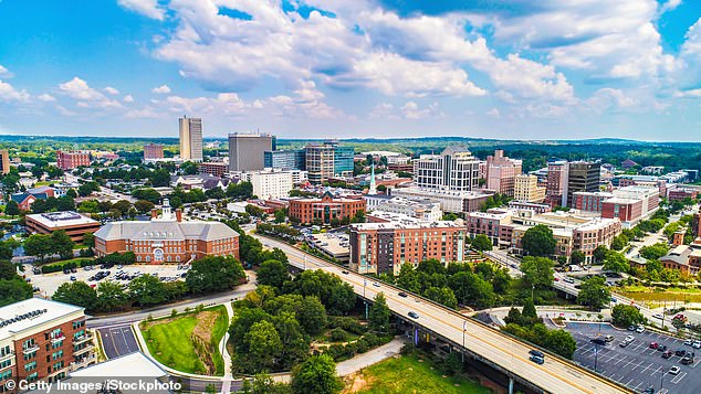 Many people have moved from blue states to southern red states attracted by lower taxes, warmer weather and a lower cost of living. Pictured is the skyline of Greenville, South Carolina.