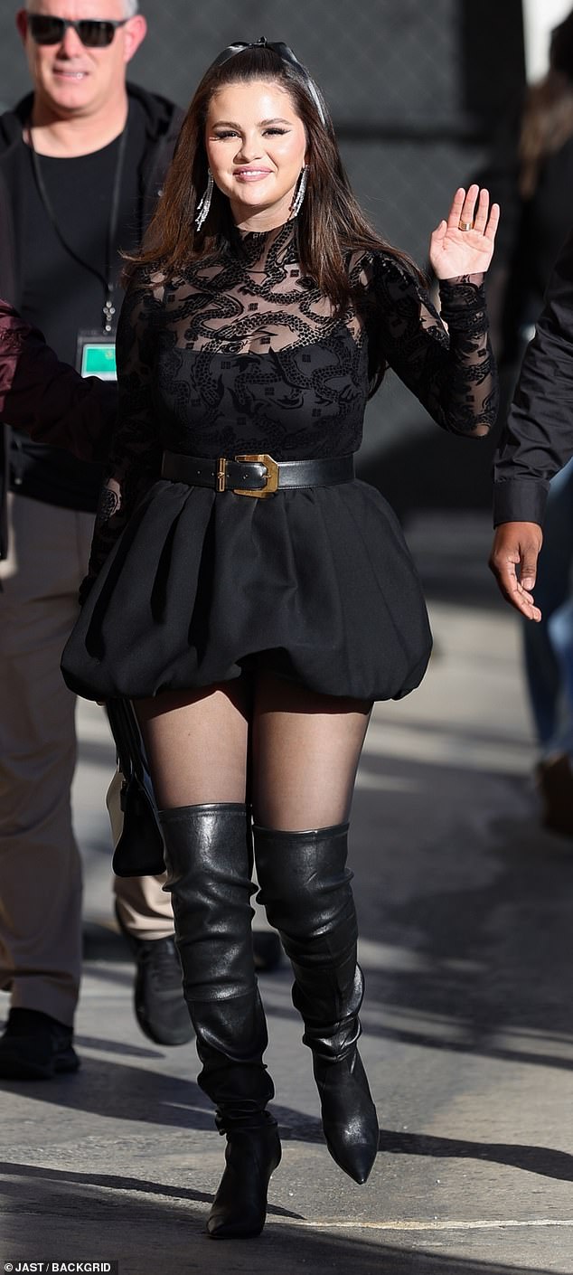 She also rocked a pair of sheer black tights and over-the-knee leather boots to complete her monochromatic look.