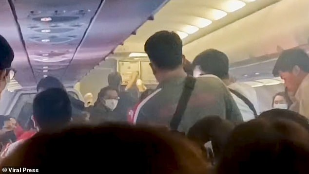 Those on board quickly got up from their seats and headed en masse to the other side of the plane, some of them with their children in their arms.