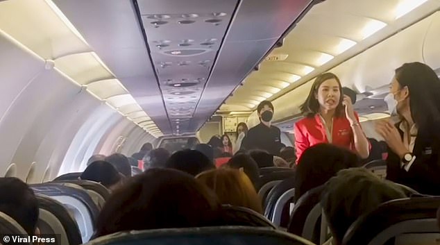 Shocked cabin crew rushed to the center row of the Airbus A320 to extinguish the flames, while nervous customers looked on.