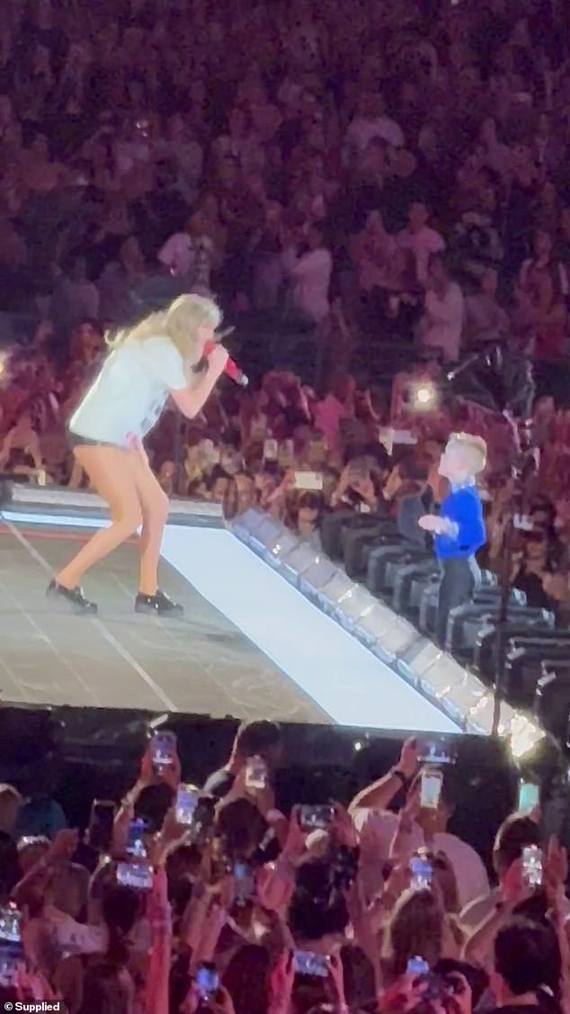 That same night, one lucky Swiftie shared an adorable moment with his idol at the show.  Taylor has established a tradition in which she gives away a signed hat to a lucky fan in the crowd while she sings her song, 22.