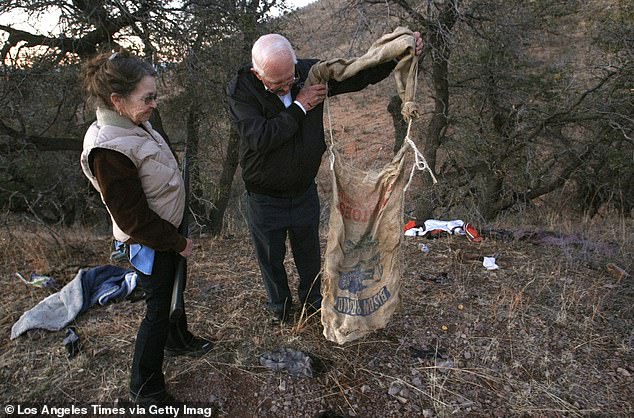Jim and Sue Chilton look at a burlap backpack that a Mexican drug dealer dropped on their ranch. When the smuggler saw Chilton's rifle, he dropped his backpack and fled. The Border Patrol later confiscated the marijuana that was inside.