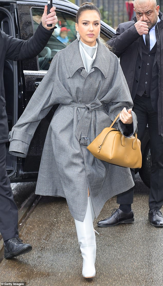 The beauty donned a light gray wool trench coat as she showcased the Italian footwear brand's collection.