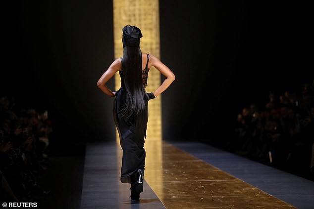 The fashion star's long mane of black hair was seen trailing behind her as she walked back down the catwalk.
