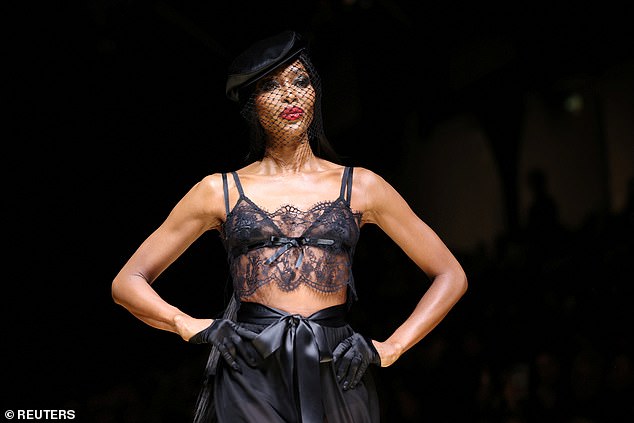 Naomi looked confident as she walked in the show, sporting a glamorous face and makeup that included a bold red lipstick.