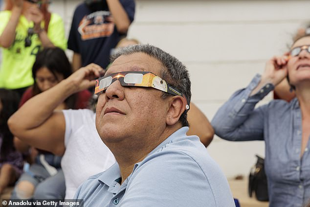 Authorities also advised residents to stay home, avoid driving, fill up vehicles ahead and buy food days before the eclipse. Pictured: People watch the annular solar eclipse in Brownsville, Texas.