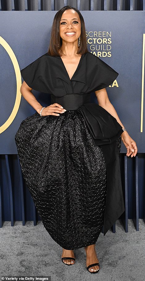 Elaine Welteroth looked like a tacky Christmas present in her gold bow dress, while Nischelle Turner (pictured) looked like she was about to be swallowed whole by the enormous fabric of her dress.