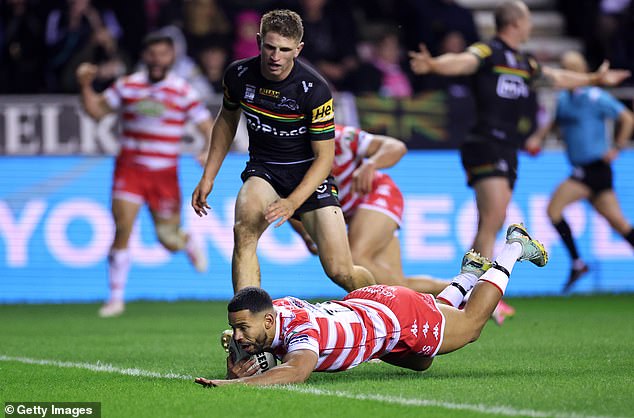 Wigan sealed a record fifth title with a thrilling 16-12 victory.