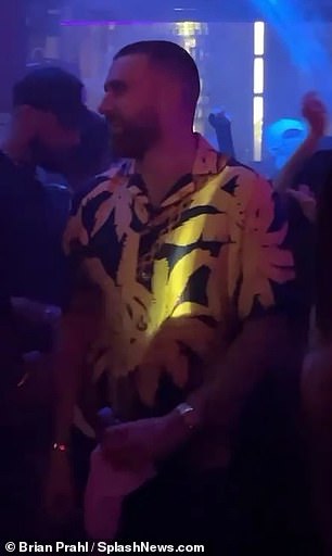 Kelce was wearing a bright yellow Hawaiian style shirt that was clearly visible.