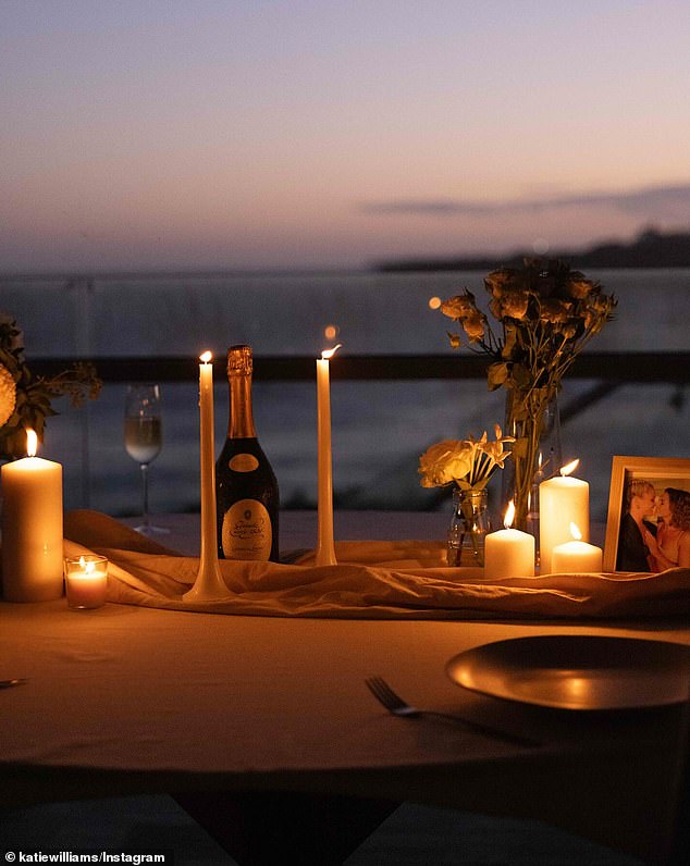 Reflecting on the proposal, Katie revealed that she had prepared a stunning beachside proposal with flowers and candles (pictured), keeping it all a Georgia surprise.