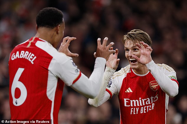 Odegaard celebrates with Gabriel Arsenal's first, Sven Botman's own goal
