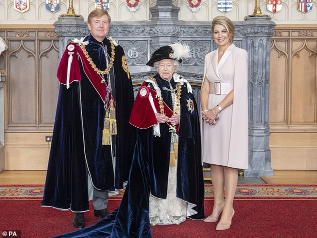 The Dutch royal can be seen posing alongside his wife, Queen Maxima, and the late Queen in the photograph, which was taken before the Order of the Garter service at St George's Chapel in 2019.