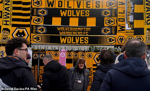 Wolverhampton Wanderers scarves and merchandise on sale outside the ground before the Premier League match at Molineux Stadium, Wolverhampton. Photo date: Sunday February 25, 2024. PA Photo. See PA story SOCCER Wolves. Photo credit should read: David Davies/PA Wire.RESTRICTIONS: FOR EDITORIAL USE ONLY May not be used with audio, video, data, fixture lists, club/league logos or "live" services. Online use during match limited to 120 images, no video emulation. Not used in betting, games or single club/league/player posts.