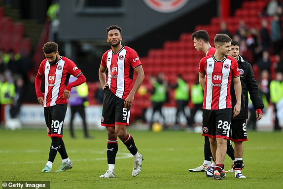 SHEFFIELD, ENGLAND - FEBRUARY 18: Auston Trusty and James McAtee of Sheffield United look dejected after the team's defeat during the Premier League match between Sheffield United and Brighton & Hove Albion at Bramall Lane on February 18, 2024 in Sheffield , England. (Photo by David Rogers/Getty Images)