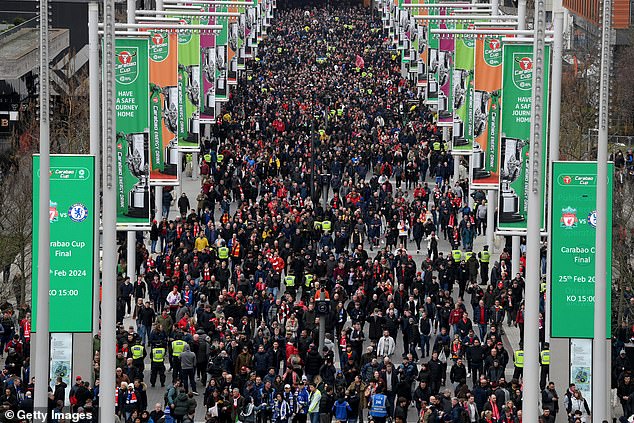 Liverpool and Chelsea fans walk along Wembley Way before kick-off.