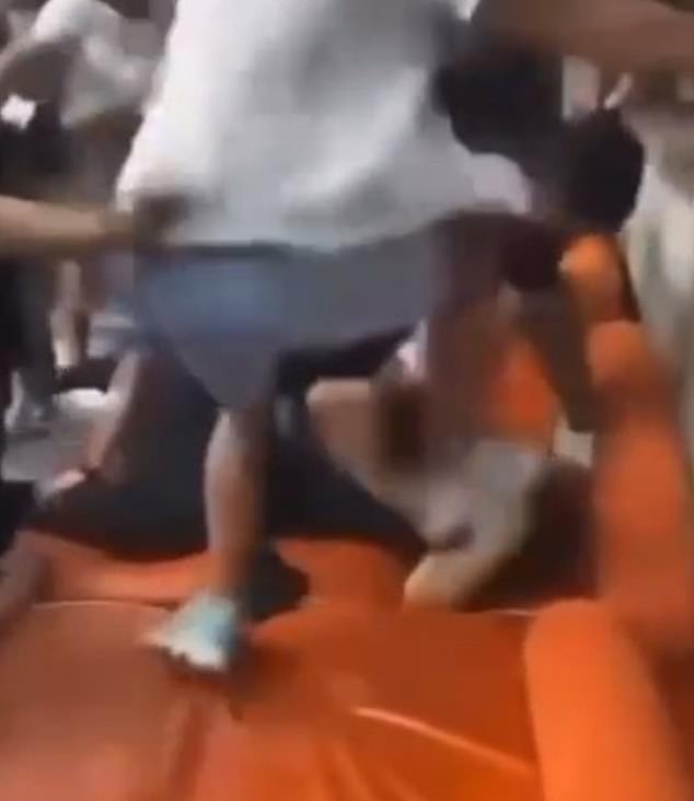 Another video showed a group of men repeatedly stomping on a man in a black T-shirt.