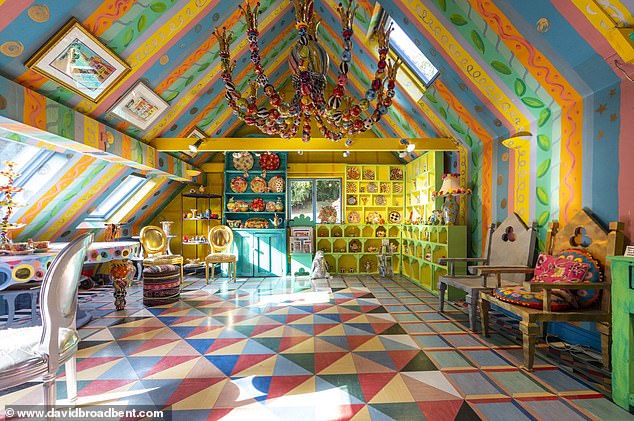 Mary's ceramics studio, where she makes her Alice in Wonderland-inspired designs, has a multi-colored striped ceiling with various floral motifs.