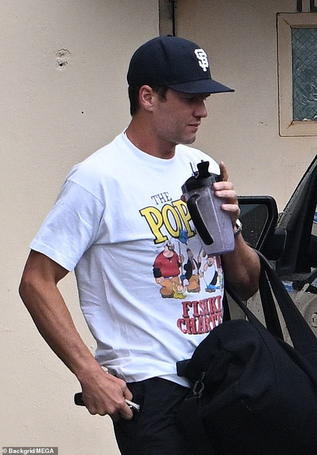 The seven-time Super Bowl champion, 45, sported a black Giants cap and a Popeye T-shirt.