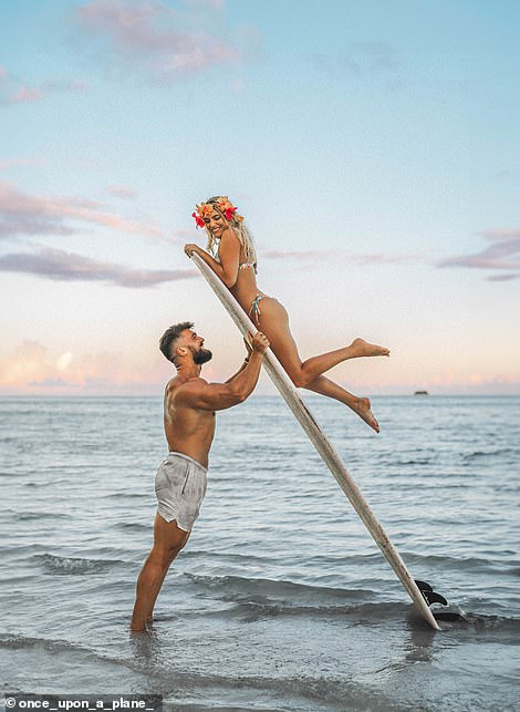 Ruan is shown here holding Lee-Chazelle on a surfboard.  The single shot was captured on the island of Siargao in the Philippines.