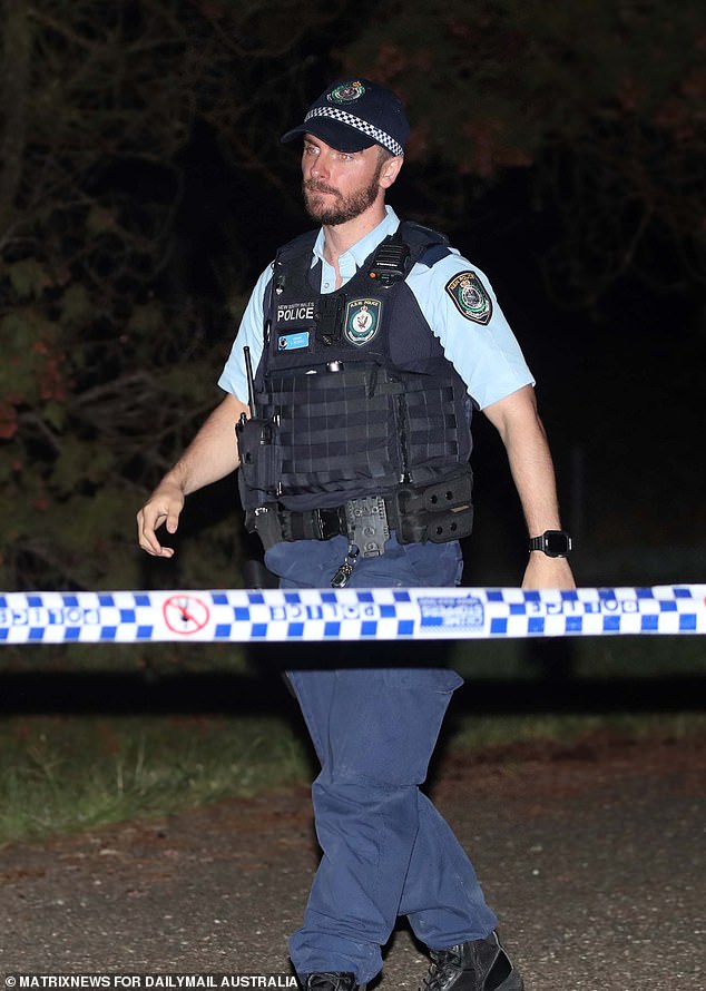 Police are relying on CCTV, road toll payments and mobile GPS data to piece together events in the days following the alleged double murder (pictured: an officer at the crime scene on Sunday night).