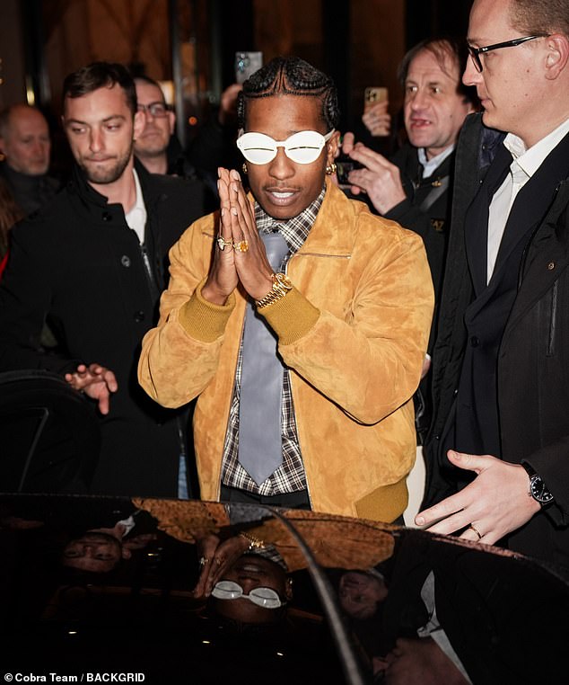 The American rapper, 35, seemed in high spirits as he left the Palazzo Parigi hotel wearing the bold glasses.