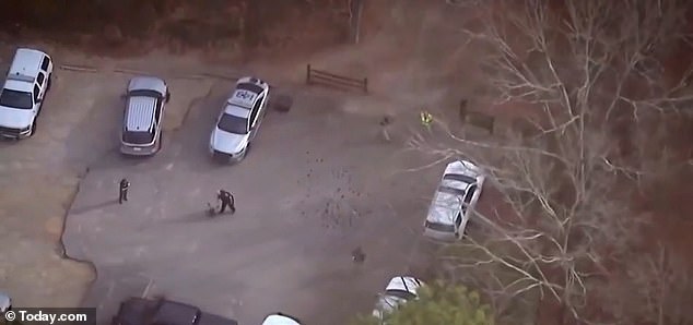 Police search a wooded area at the University of Georgia after Thursday's shocking discovery.