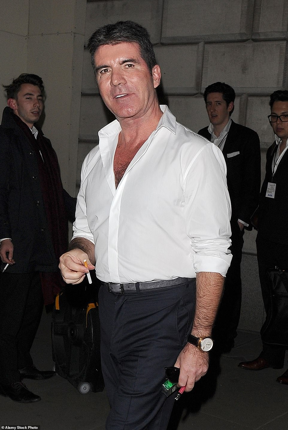 2015: Cowell, a career smoker, prepares to light up as he leaves a private function in London.