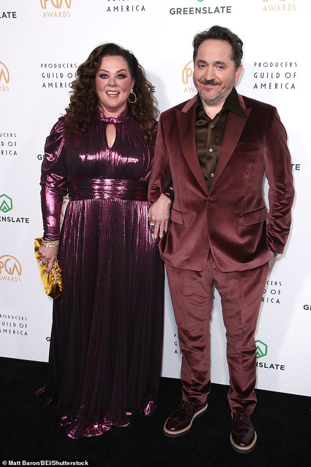 Her husband Falcone, whom she married in 2005, opted for a burgundy suit coat under a dark brown dress shirt without a tie.