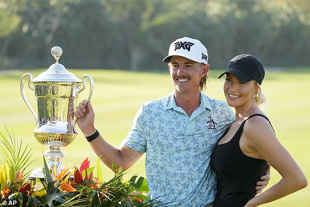 The American debutant poses with the trophy with his girlfriend Makena White