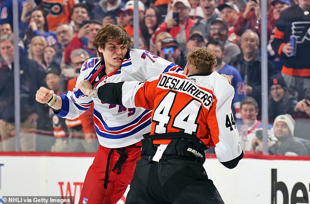 Rempe (in white) is seen with some damage to his face during the fight with Deslauriers