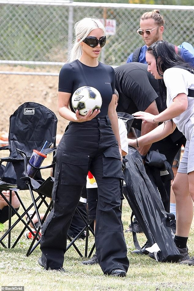 Kim has often been photographed attending her eight-year-old son's games and even took her 'football-obsessed' son to several professional games this year; seen at his game in may