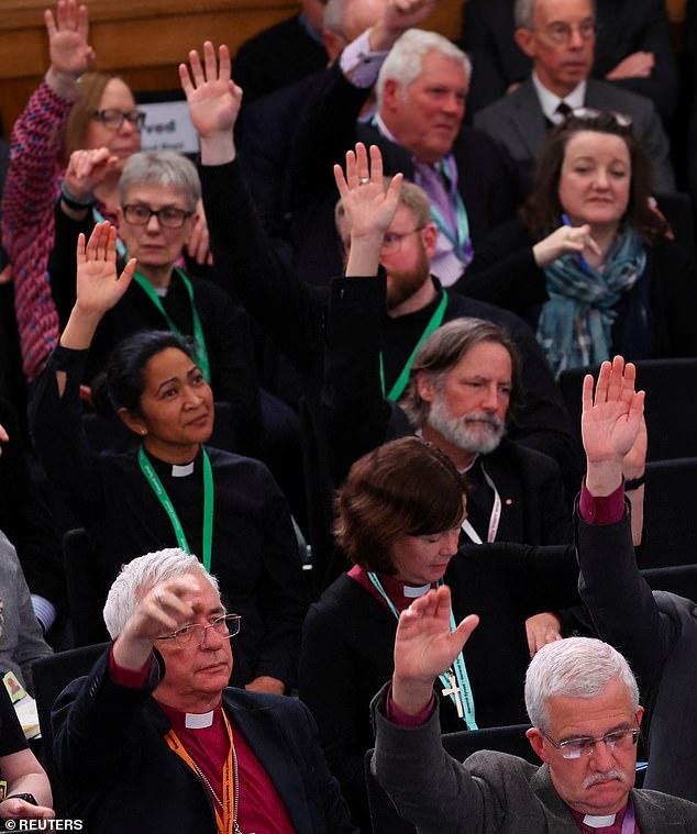 Delegates vote during the opening session of the General Synod of the Church of England