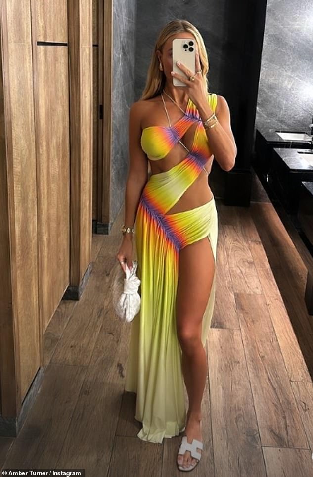 While heading to dinner, Amber turned heads as she dressed in a daring yellow cut-out maxi dress that featured a daring thigh-high slit.