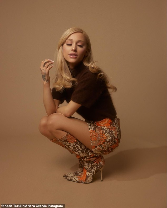 Grande, who captioned the post Eternal Sunshine after the album's name, wore an espresso brown high-neck velvet top with an orange/brown floral print mini skirt and matching knee-high boots with stiletto heels.