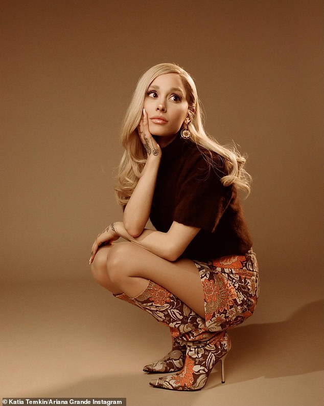 The singer used her official Instagram account to upload the images that show her posing in a squatting position with one hand under her chin and the other on her lap. She is seen against a monotone beige background of a photo studio. Her long blonde hair is parted to the side with a few curls at the ends, cascading down her back.