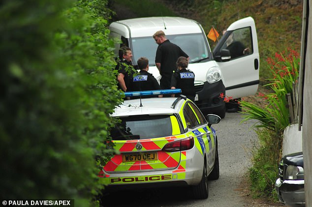 Police officers at the scene at his isolated home in Kittywell Wood in Knowle, North Devon, on August 24, 2022.
