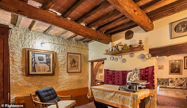 The property includes many period features including decorative wooden beams to the ceiling and doors.