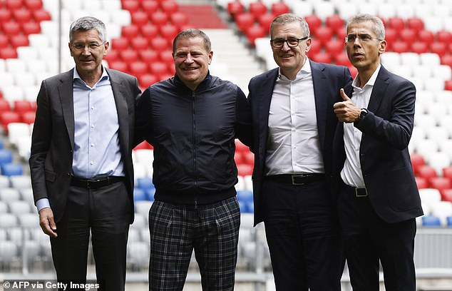 Eberl posed with Herbert Hainer (left), Jan-Christian Dreesen and Michael Diederich (right) at the Allianz Arena on Tuesday.