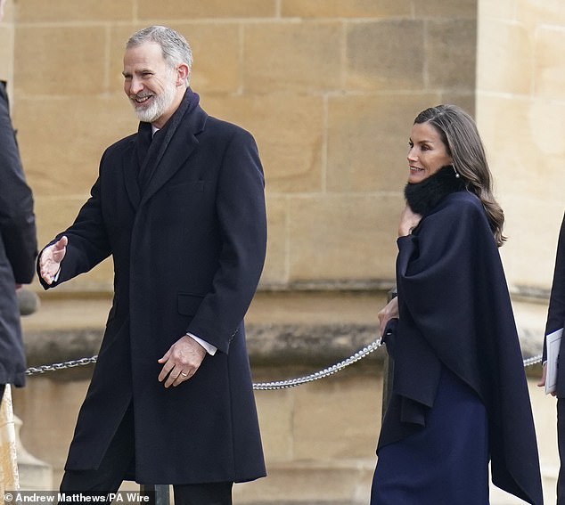 The European monarch, 51, looked solemn in a knee-length navy blue dress, which she paired with matching heels and a shawl.